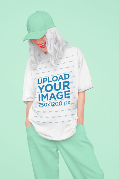 Mockup of a Happy Woman Wearing an Oversized T-Shirt at a Studio 