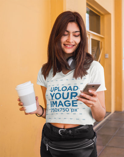 Crop Top Mockup Featuring a Young Happy Woman Checking Her Phone 