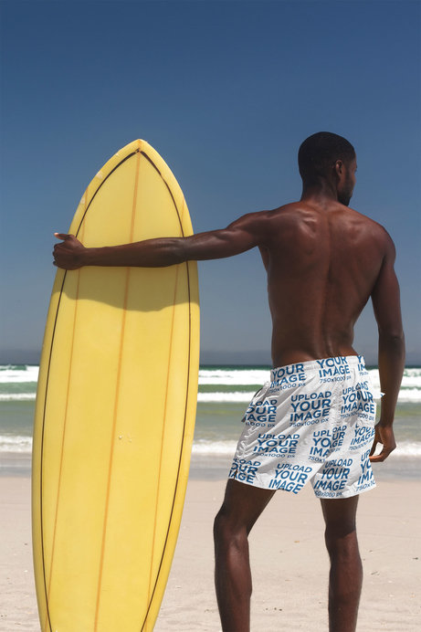 Back View Mockup of a Man Wearing Swim Trunks at the Beach 