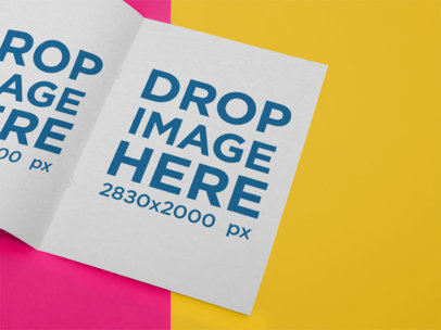 Open Booklet Mockup Lying on a Two Colors Surface