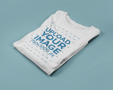 Longsleeved T-Shirt Mockup Lying Folded on a Solid Surface