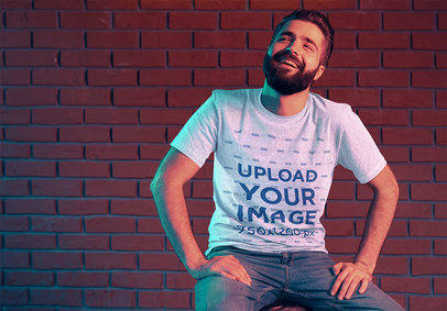 T-Shirt Mockup of a Happy Bearded Man Against a Brick Wall 