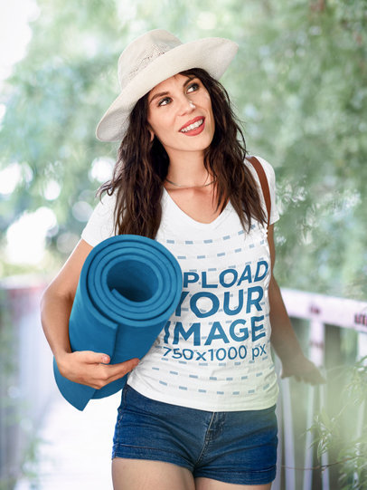 V-Neck Tee Mockup of a Woman Walking Through a Wooden Bridge