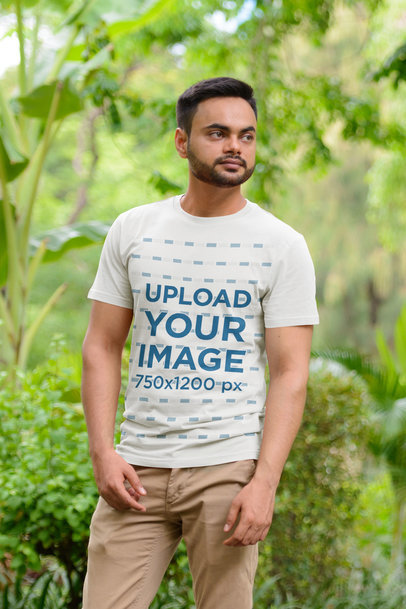 T-Shirt Mockup of a Bearded Man Standing by Tall Plants
