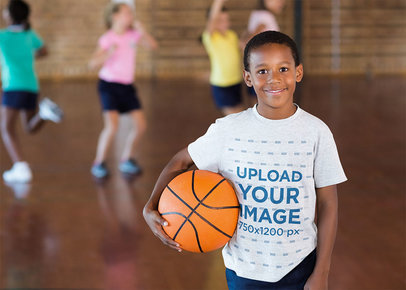 Heathered Tee Mockup Featuring a Boy Training Basketball