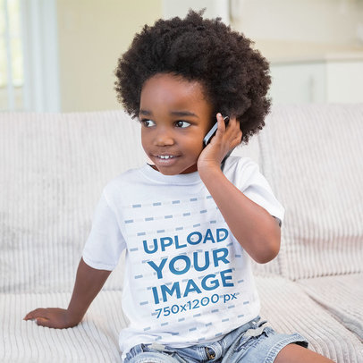T-Shirt Mockup Featuring a Boy with a Phone at Home
