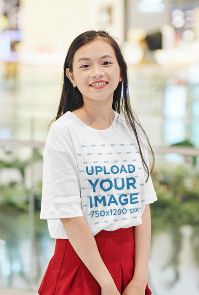 Mockup of a Woman Wearing an Oversized T-Shirt at a Mall
