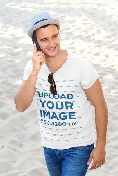 T-Shirt Mockup Featuring a Man on the Phone at the Beach