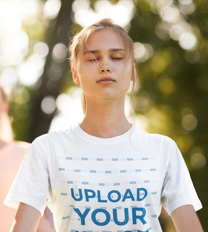T-Shirt Mockup of the Closeup of a Young Woman Meditating in a Park