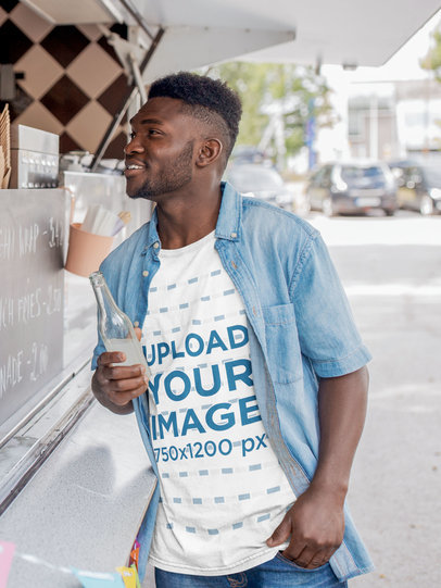 T-Shirt Mockup Featuring a Man Ordering at a Food Truck