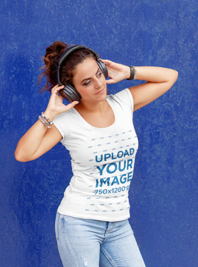 T-Shirt Mockup Featuring a Woman Listening to Music Against a Colored Wall 