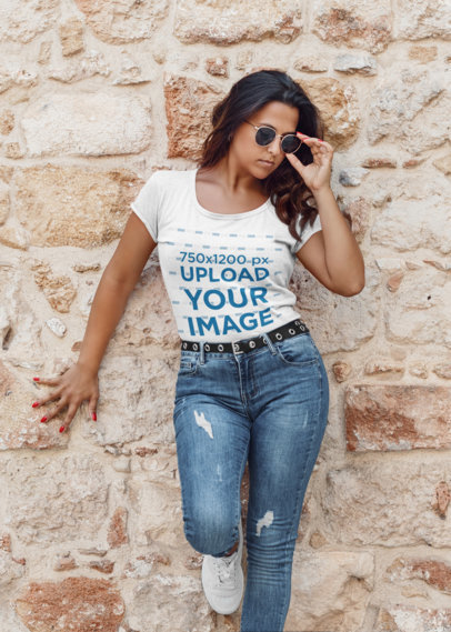 T-Shirt Mockup of a Trendy Woman Posing by a Rocky Wall