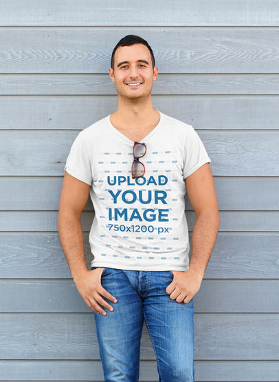 T-Shirt Mockup Featuring a Man Leaning Against a Wall 