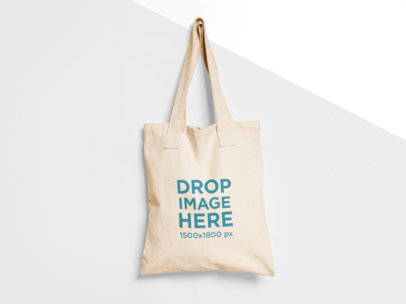 Tote Bag Mockup Hanging from a Nail on a Two Colors Wall a15313