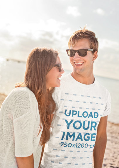 T-Shirt Mockup of a Man Walking by the Beach with His Girlfriend