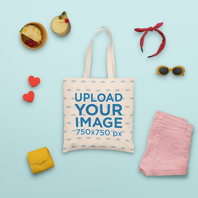 Mockup of a Tote Bag Surrounded by Summer Accessories and a Tropical Drink 
