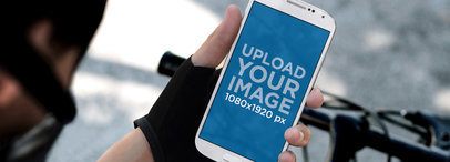 Samsung Galaxy S4 Mockup Featuring a Man on a Bike