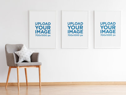 Mockup of Three Framed Art Prints Hanging Near a Chair 