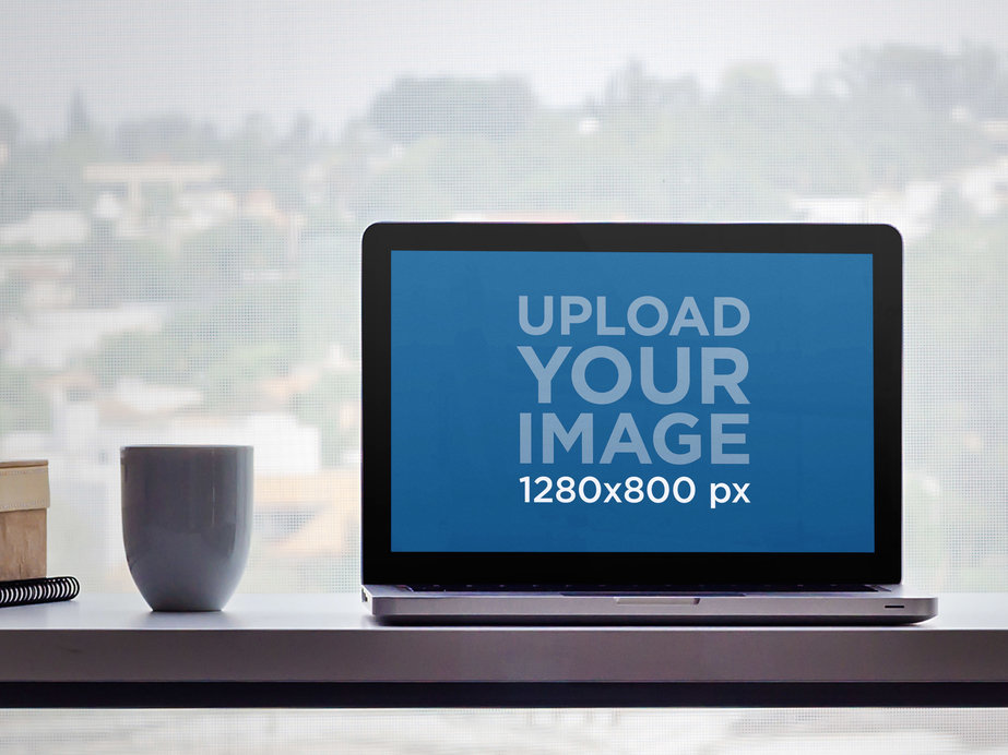 MacBook Pro Mockup Featuring a Desk Against an Urban View
