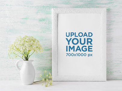 Mockup of a Small Art Print Placed Next to Some Flowers