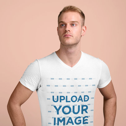 V-Neck T-Shirt Mockup of a Serious Man Posing Against a Plain Color Background 