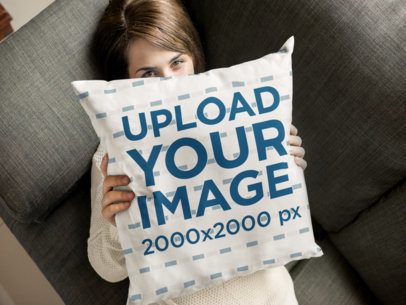 Young Woman Hiding Behind a Square Pillow Mockup