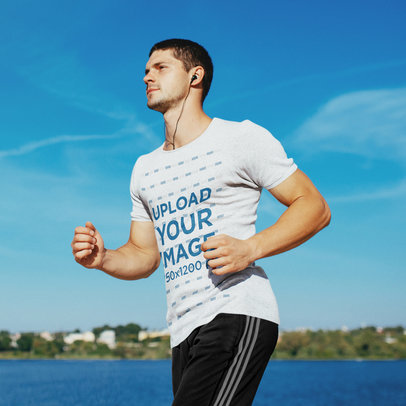 Activewear Mockup of a Man Wearing a Heathered T-Shirt While Jogging by a Lake 