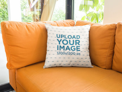 Square Pillow Template Lying on an Orange Sofa in a Living Room