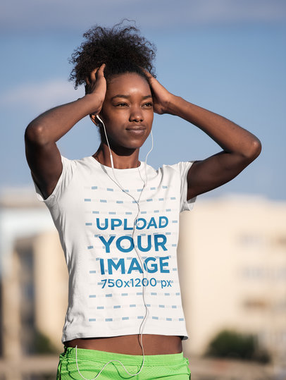 T-Shirt Mockup of a Woman Listening to Music Before an Outdoor Run