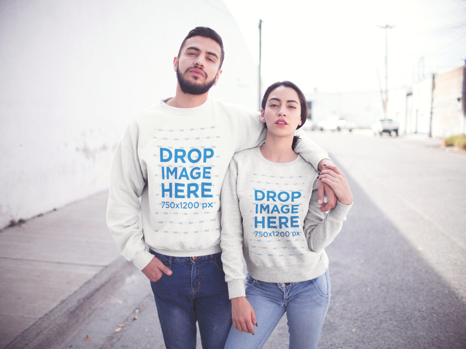 Young Hispanic Couple Walking in the City While Wearing Different Crewneck Sweatshirts Mockup