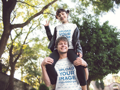 Young Couple Wearing Different T-Shirts Mockup While Playing in the Park