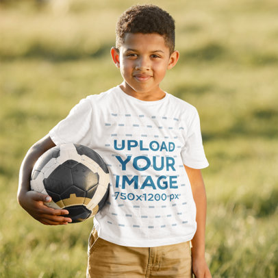 Round Neck T-Shirt Mockup of a Boy Holding a Soccer Ball