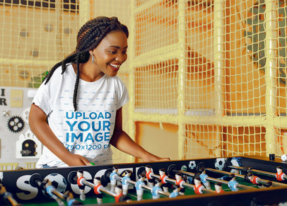 Basic T-Shirt Mockup of a Woman Happy Woman Playing Foosball 