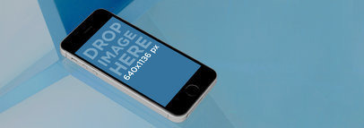 Mockup of a Space Grey iPhone 5S over a Glass Table