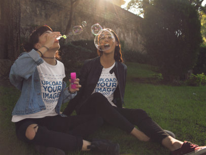 Two Girlfriends Playing With Bubbles While Wearing Different Tees Outdoors a13389