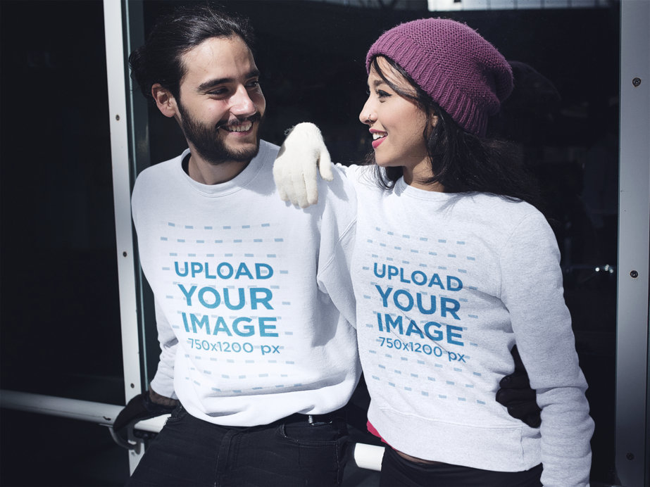 Happy Young Couple Wearing Different Crewneck Sweatshirts While at an Ice Skating Park