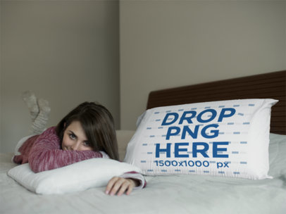 White Woman Lying in Bed with a Big Pillow Mockup Beside Her