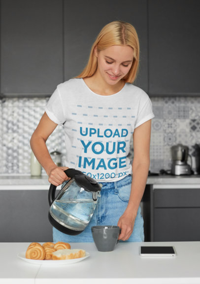 Tee Mockup of a Woman at a Kitchen Pouring Herself Some Water