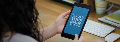 Overshoulder Mockup of a Woman Using a Nexus 7 in Portrait Mode