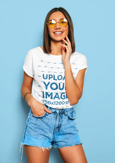 T-Shirt Mockup of a Happy Young Woman Modeling a Fresh Outfit in a Studio