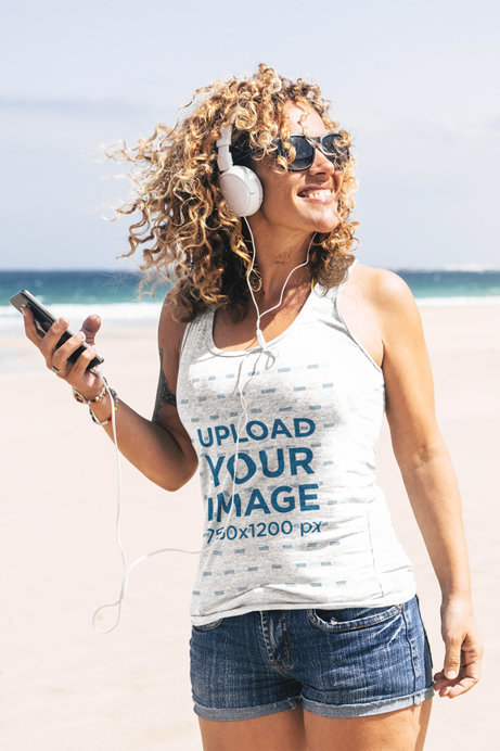 Tank Top Mockup of a Happy Woman Listening to Some Music by the Sea