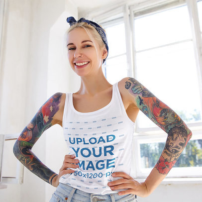 Tank Top Mockup of a Happy Woman With Tattoos Posing By a Window 
