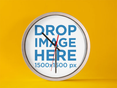 Round Clock Mockup Standing on a Solid Color Surface