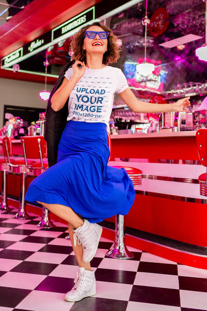 T-Shirt Mockup of a Happy Woman Dancing at a Retro Diner 