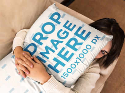 Young Woman Holding a Big Pillow Mockup While Lying Down