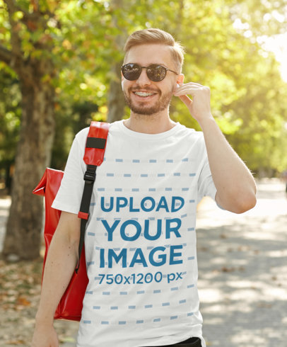 T-Shirt Mockup of a Bearded Man with Braces Walking at a Park