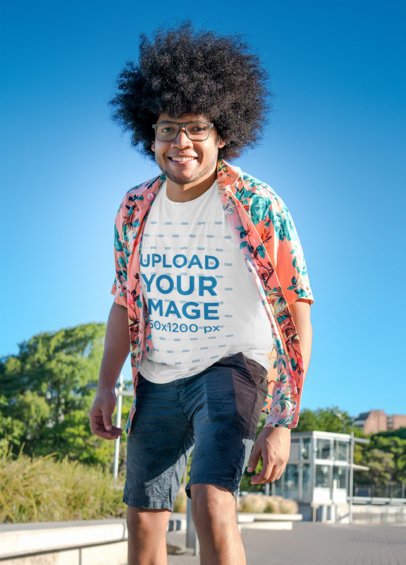 T-Shirt Mockup of a Happy Curly-Haired Man at a Park 