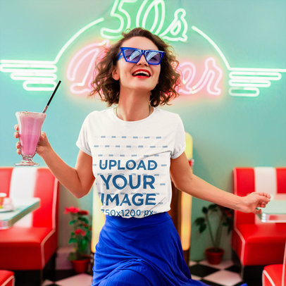 T-Shirt Mockup Featuring a Happy Woman Holding a Strawberry Milkshake 