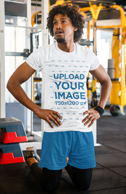 Round-Neck Tee Mockup of a Kneeled Man at a Gym