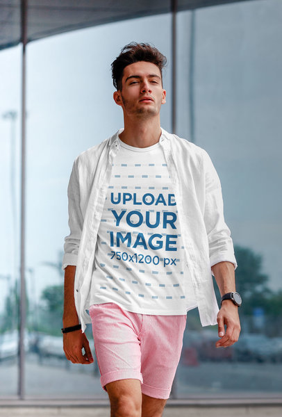 T-Shirt Mockup Featuring a Stylish Man Walking Down the Street